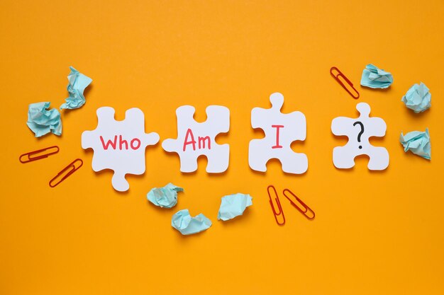 Photo puzzles with letters papers and paper clips on orange background top view