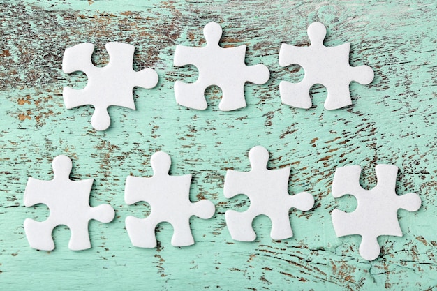 Puzzles on wooden table closeup