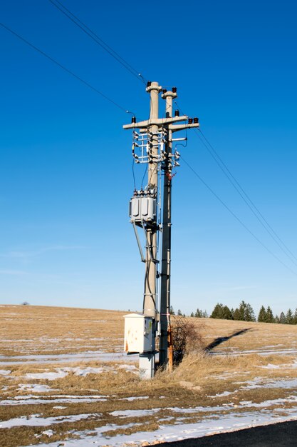 Pylon and transmission power line in winter