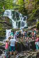 Photo pylypets ukraine august 4 2018 tourists taking picture near waterfall