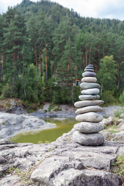 A pyramid of bare stones stacked on top of each other. Stones stacked in the shape of a pyramid