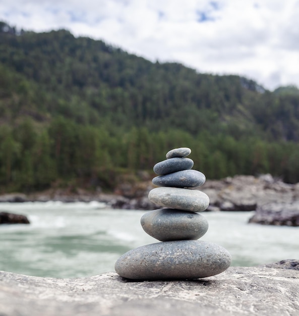 A pyramid of bare stones stacked on top of each other. Stones stacked in the shape of a pyramid