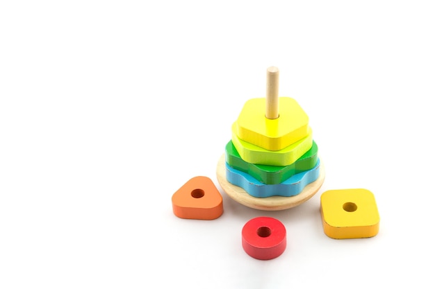 Pyramid build from colored wooden rings. Toy for babies and toddlers to joyfully learn mechanical skills and colors. Isolated on white background.