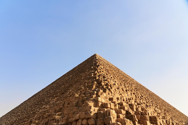 The pyramid of Cheops with a blue sky in the background.