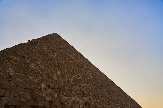 The pyramid of Cheops with a blue sky in the background.