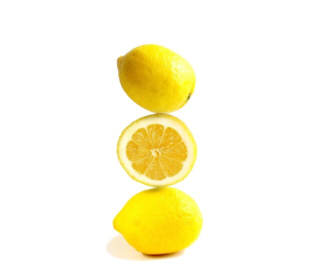 Pyramid of juicy yellow lemons on a white background Balance concept