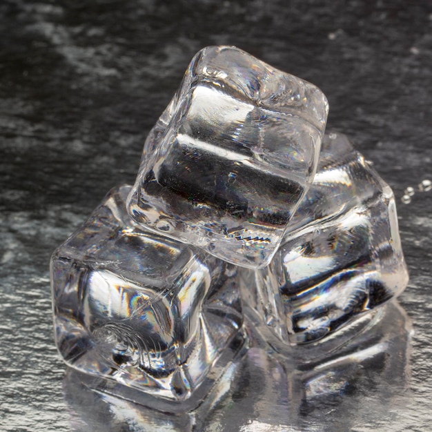 Pyramid of melted ice cubes with drops close up