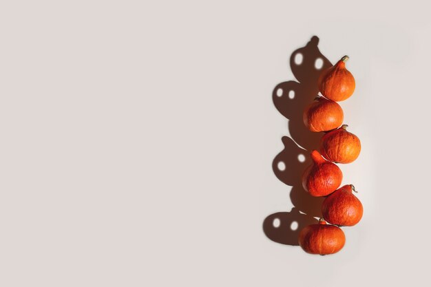 A pyramid of orange pumpkins with funny ghost shadows with eyes.