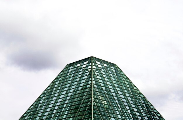 A pyramid shaped building with many windows and the word the word on it