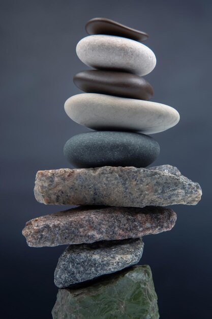 Pyramid of stacked stones on a dark background stabilization and balance in life