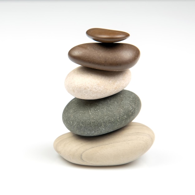 Pyramid of stacked stones on a white background stabilization and balance in life