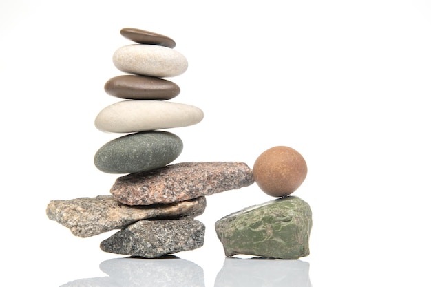 pyramid of stacked stones on a white background stabilization and balance in life