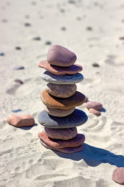 Pyramid of stones on a sandy beach Zen balance stones