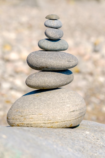 Pyramid of stones. Unstable balance of stone objects. Idyllic state of nature.