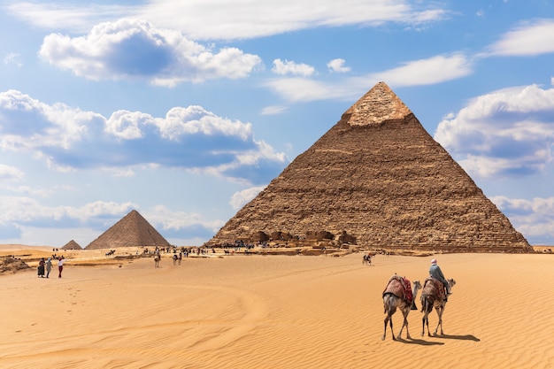 The Pyramids and bedouins in the desert of Giza, Egypt.