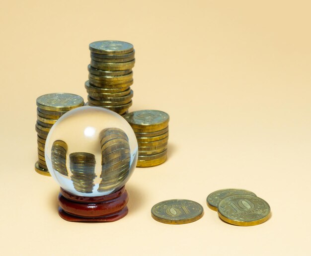 Pyramids of coins are reflected in a glass ball