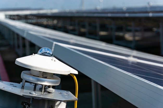 Photo pyranometer for measuring irradiance in solar farm with blue sky,solar cell plant.