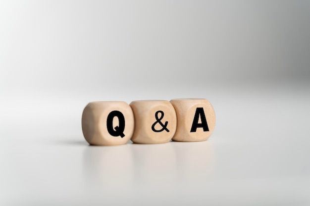 Q and A an abbreviation of wooden blocks with letters on a white background Question and Answer