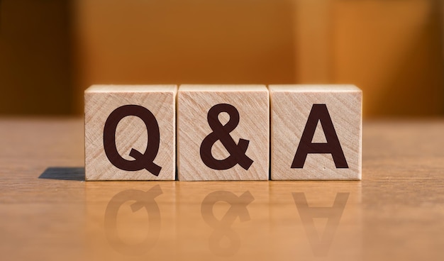 QA or Questions and answers text on wooden blocks