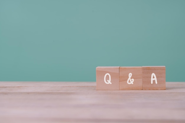 QampA or Q and A with wooden blocks with letters questions and answers customer service and support  concept  Copy space