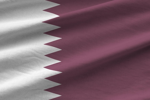 Qatar flag with big folds waving close up under the studio light indoors the official symbols and co