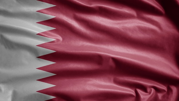 Qatari flag waving in the wind. Close up of Qatar template blowing, soft and smooth silk. Cloth fabric texture ensign background