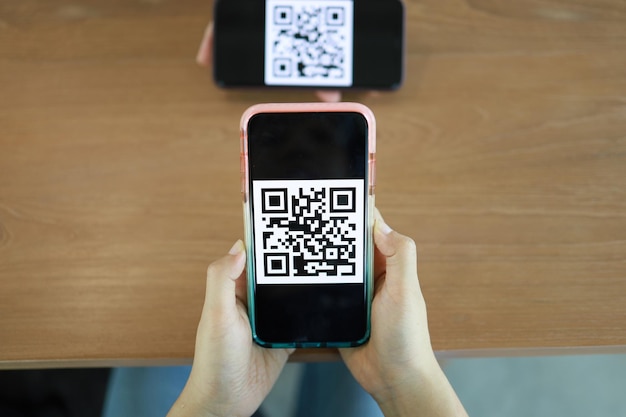 Qr code payment Woman scanning QR code online shopping cashless technology concept