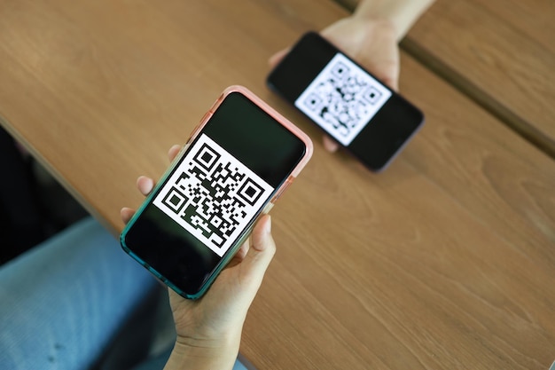 Qr code payment Woman scanning QR code online shopping cashless technology concept