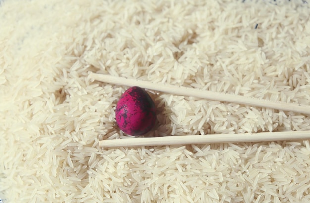 an quail egg painted in pink on rice