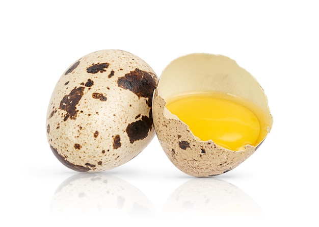 Quail egg with broken one isolated on white background Close up