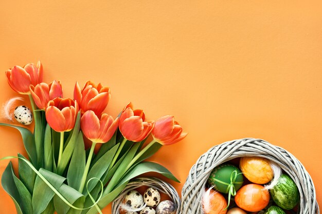 Quail eggs in bird nest, Spring tulips, envelope and flower decorations. 