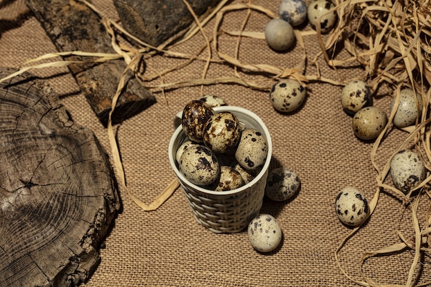 Quail eggs over dark old wooden background.