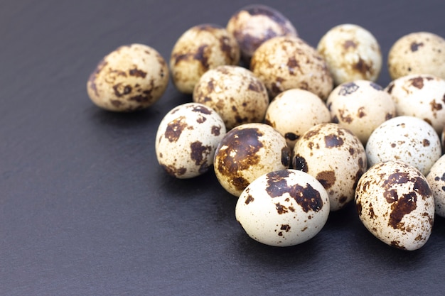 Quail eggs on a dark