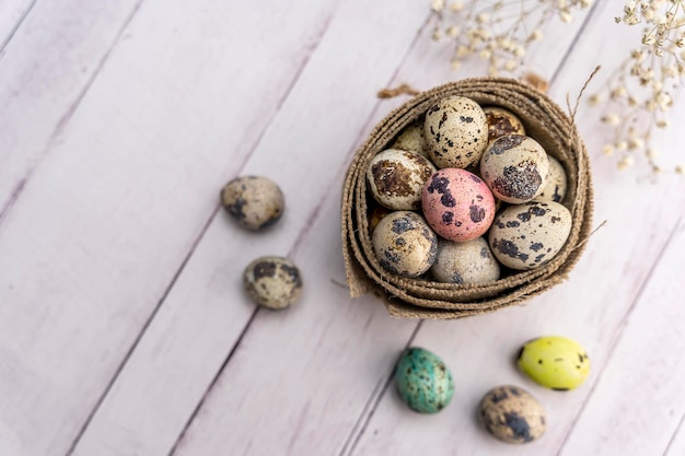 Quail eggs in a decorative matting nest on the table