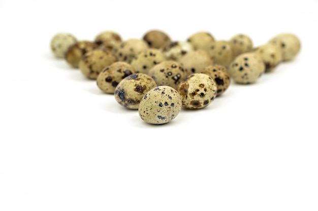  quail eggs on a light background. Focus on quail eggs.