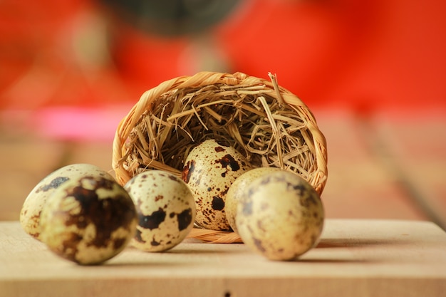 Quail eggs in a nest on a rustic wooden background. Healthy food.