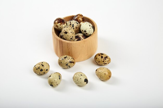 Quail eggs in a wooden bowl,.