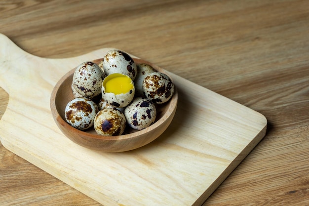 Quail eggs in wooden bowl