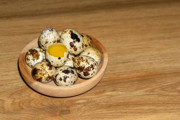 Quail eggs in wooden bowl