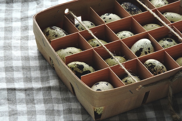 Quail eggs in a wooden box. Homemade quail eggs. Eco food.