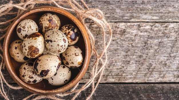 Quail eggs on wooden surface. Top view.