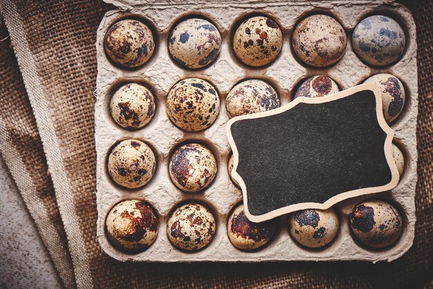 Quail eggs on wooden table decorated in a rustic style for Easter close-up with empty copy space for text