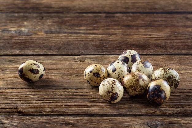 Quail eggs on a wooden table.