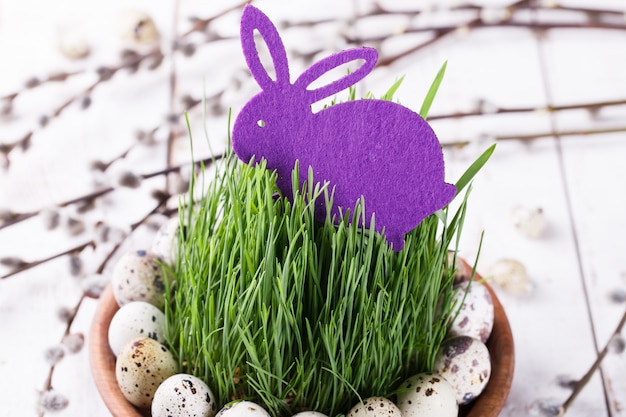 Quails egg on grass in a brown flowerpot