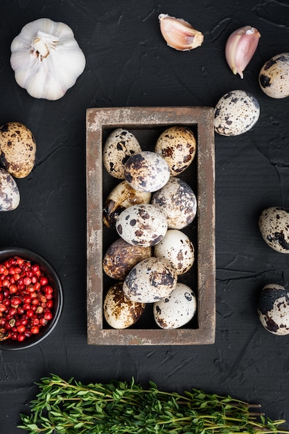 Quails eggs, top view, on black table