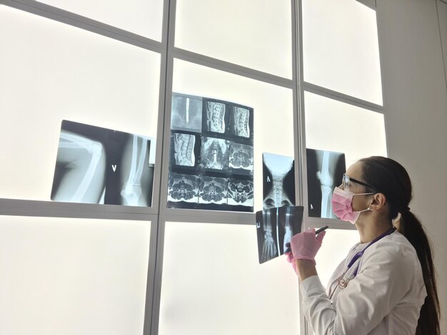 Qualified female doctor examine x ray scan of patients lungs