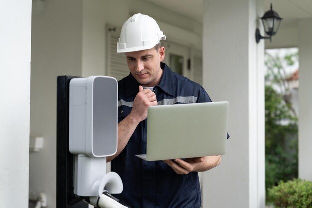 Photo qualified technician working with laptop for home ev station synchronos