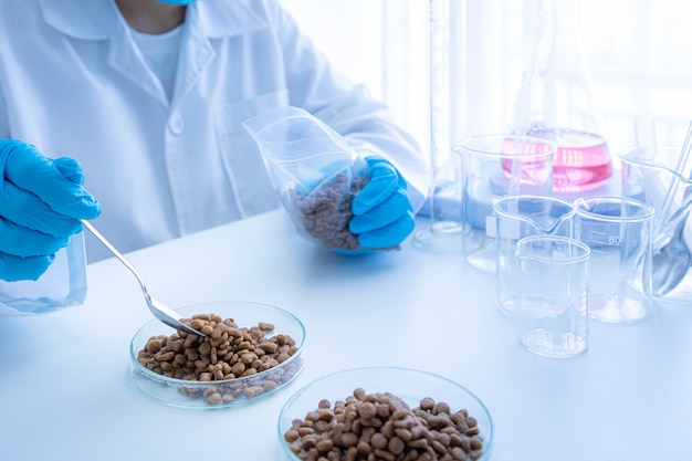 Quality control personnel are inspecting the quality of pet food. Quality control process in pet food industry.