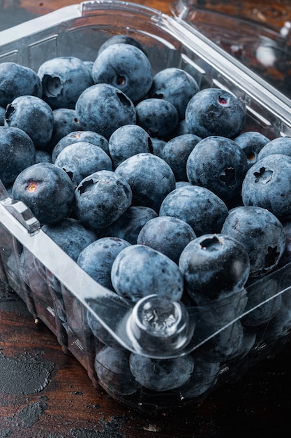 Quarts of blueberries, on old dark  wooden table background