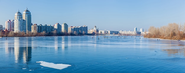 Quay in Kiev frozen lake in the urban landscape man on winter fishing